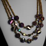 Three strands of gold ceramic and bronze/purple AB coated ladder faceted purple coin beads and black crystal cubes.18"-23".